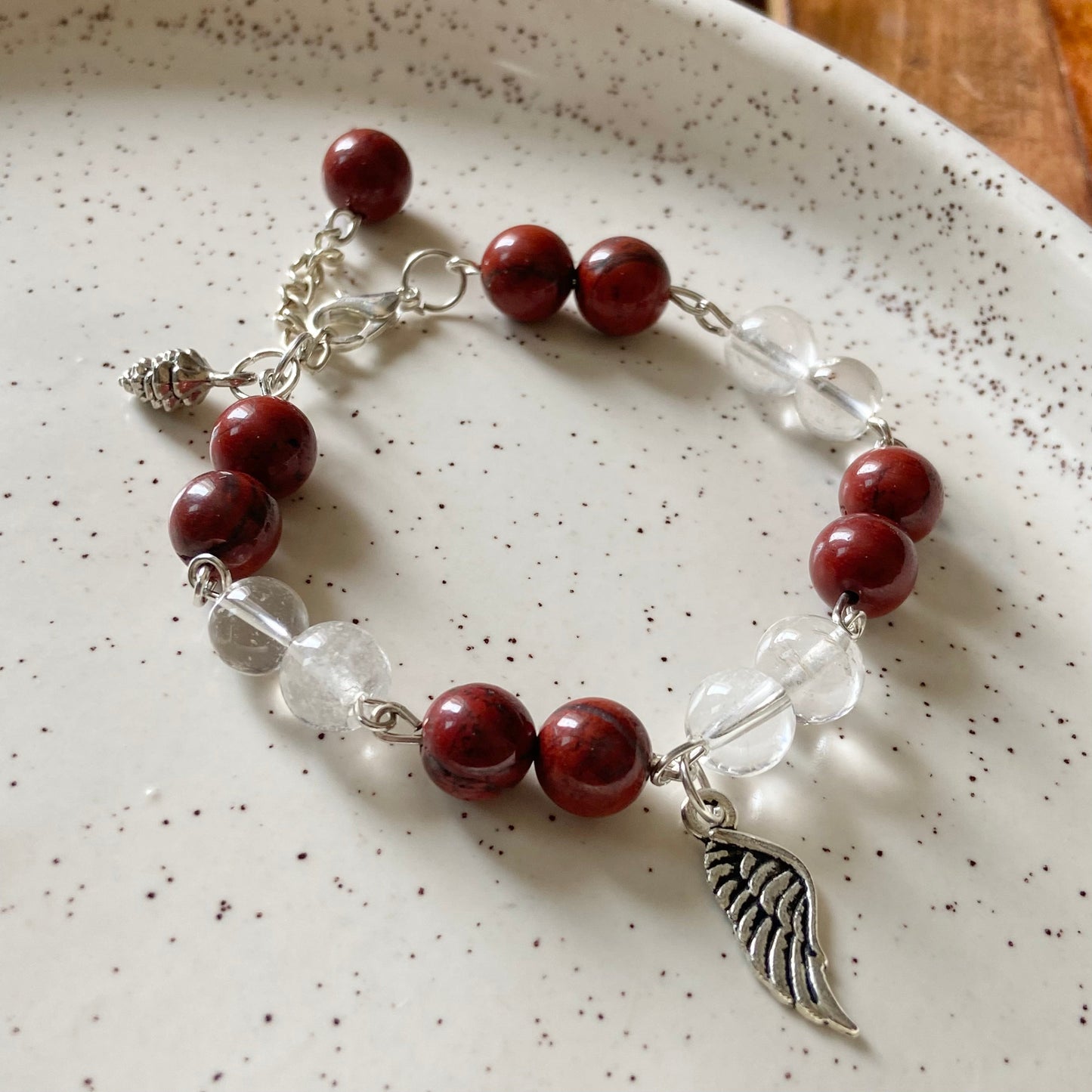 Bracelet associated with Clarity & Well-being | Red Jasper & Clear Quartz with Angel wing Charm