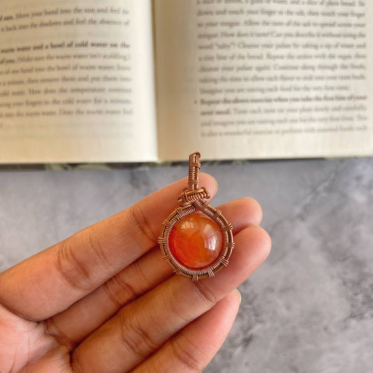 Orange Carnelian sphere copper wire wrapped pendant